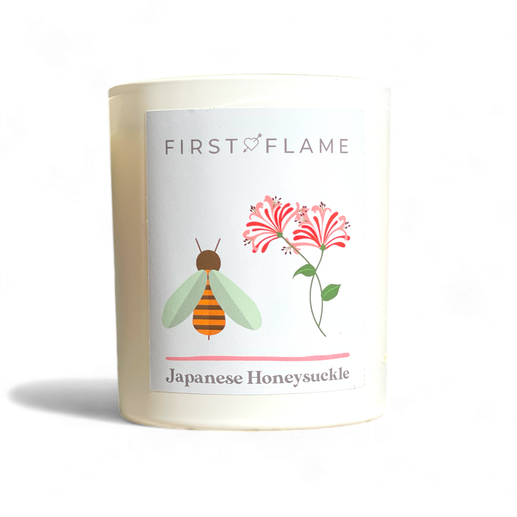 Matte white soy candle labelled Japanese Honeysuckle with bee and flower design